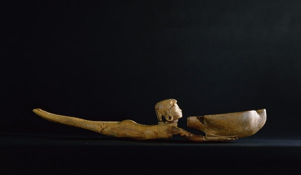 A cosmetic dish with a handle carved in the form of a swimming girl