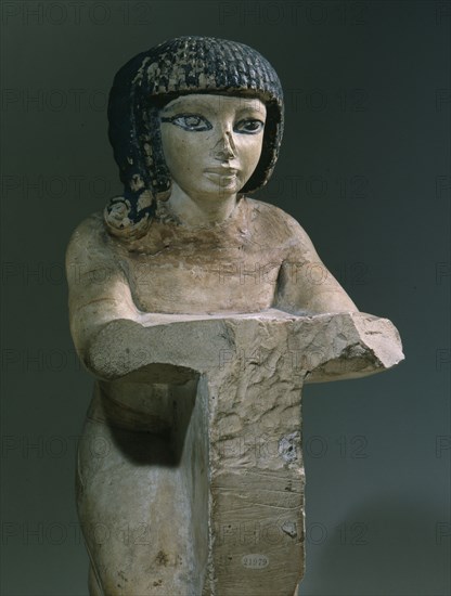 Painted stone figure of a kneeling woman, from an offering scene