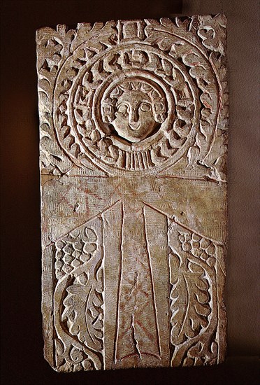Early Christian stela incorporating a looped cross (crux ansata) or ankh symbol, surrounded by the vine of eternal life, illustrating the fusion of pharaonic iconography with Christian motifs in Byzantine Egypt