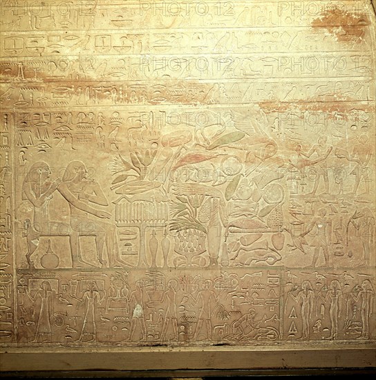 Stela showing the tomb owner with his wife and assorted offerings