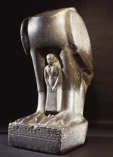 Green basalt figure of a falcon with votary, from the reign of King Nectanebo