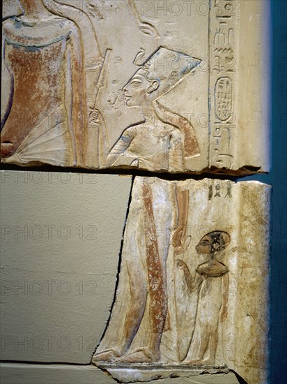 Sunk relief from the facade of a shrine showing Akhenaten and Nefertiti offering libations to Aten, the sun god