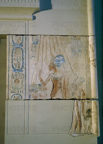 Sunk relief from the facade of a shrine showing Akhenaten and Nefertiti offering libations to Aten, the sun god