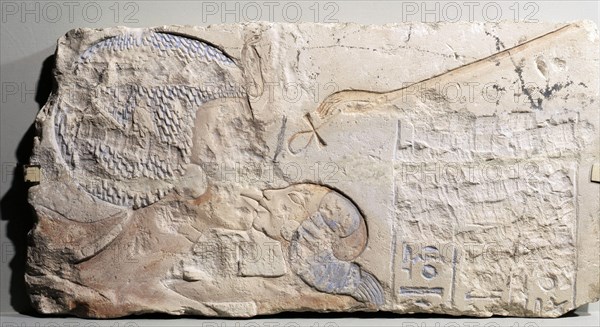 A fragment of a relief showing Nefertiti kissing her daughter, perhaps Merytaten, under the rays of the Aten