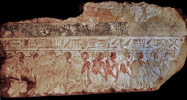 Block from a painted relief showing a parade of soldiers carrying shields,lances and sickles