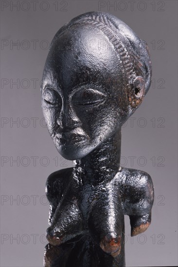 Wooden figure of Luba woman, served as a prestige possesion of a chief or king, illustrating the social and political importance of royal women in Luba society