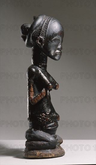 Wooden figure of Luba woman, served as a prestige possesion of a chief or king, illustrating the social and political importance of royal women in Luba society