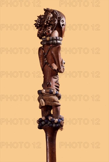 Wooden figure of a young Luba girl decorated with beads and body scarification, forming the finial of a chief or kings staff or sceptre