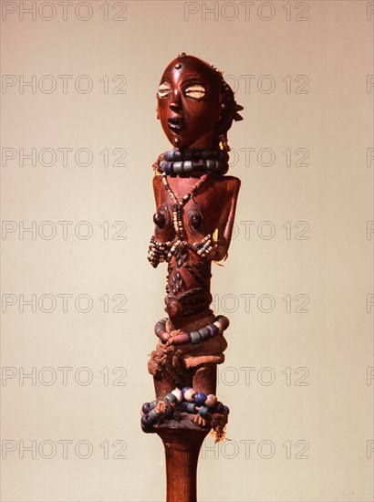 Wooden figure of a young Luba girl decorated with beads and body scarification, forming the finial of a chief or kings staff or sceptre