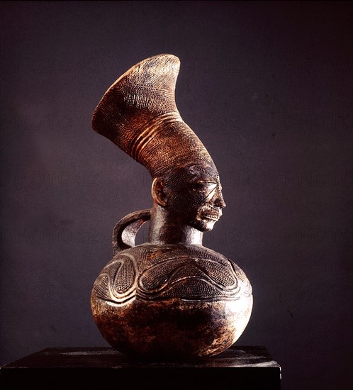 Jar depicting the womens headdress and the lengthened skull achieved by binding the heads of babies among the Mangbetu