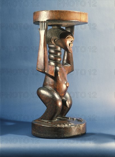 Stool supported by a male figure, served as an emblem of status and prestige for Songye chiefs