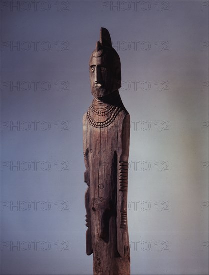 Wooden memorial statue used as a grave marker