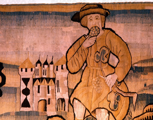 A detail of a tapestry depicting work in the vineyards