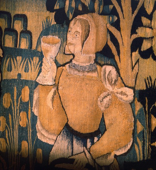 A detail of a tapestry depicting work in the vineyards