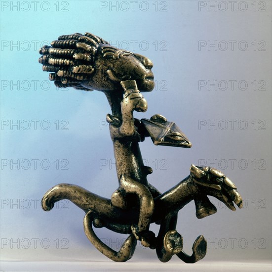 A brass weight for weighing gold dust in the form of a horse and rider