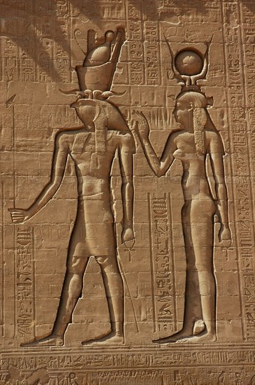 Reliefs on the outer back walls of the temple complex depicting a pharaoh and the goddess Isis