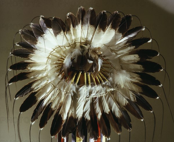 The eagle feather war bonnet, symbol of the outstanding warrior and a source of spiritual power and inspiration, utilized an ingenious method of rawhide strap attachments that made the feathers movements echo the eagles, thus imparting the eagles gift of graceful and noiseless approach to the warrior
