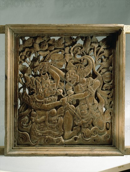 Wooden window panel from a temple, depicting Hanuman fighting a demon, a scene from the ancient Hindu epic, the Ramayana