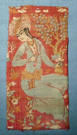 A compound silk cloth with a design by Rizzi i Abbasi of a youth drinking from a cup and flask