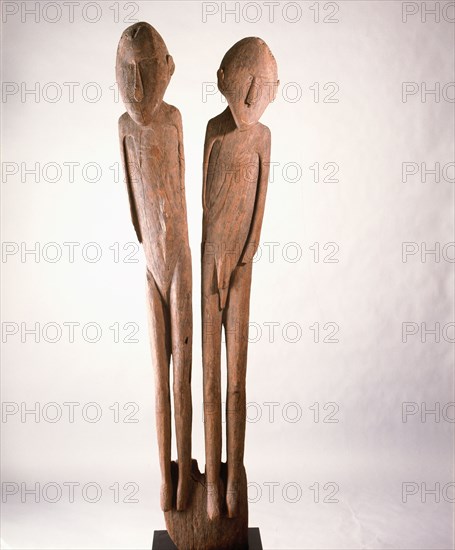 A carving depicting paired male and female clan ancestors, from a Lake Sentani mens meeting house