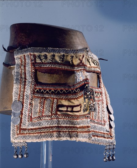 A womans veil embrodered with silve wire and decorated with coins and bells