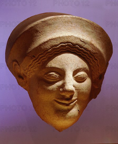 A terracotta mask of a woman