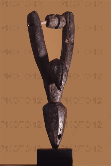 Heddle pulley used to support the cord to the foot pedals which alternate the heddles on the narrow strip loom typical of West African mens weaving