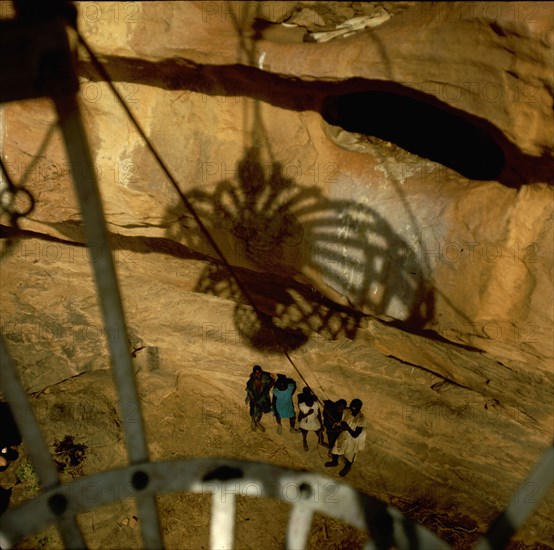 A spherical container in which people are pulled up the sheer face of the Bandiagara cliffs