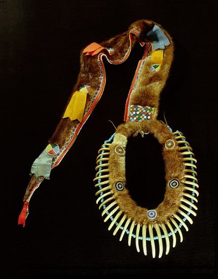 Necklace with a matched row of grizzly bear claws worn as a mark of distinction