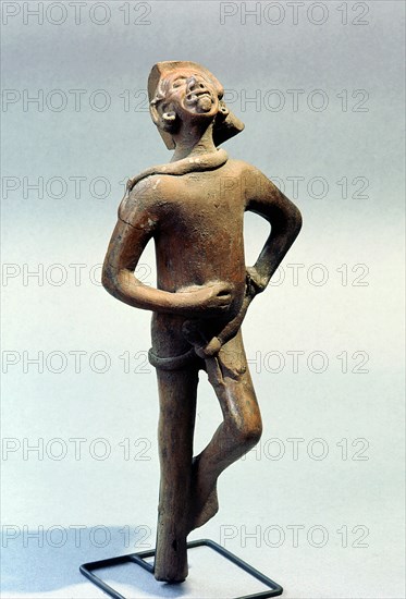 Figurine of a man singing and dancing at a festival