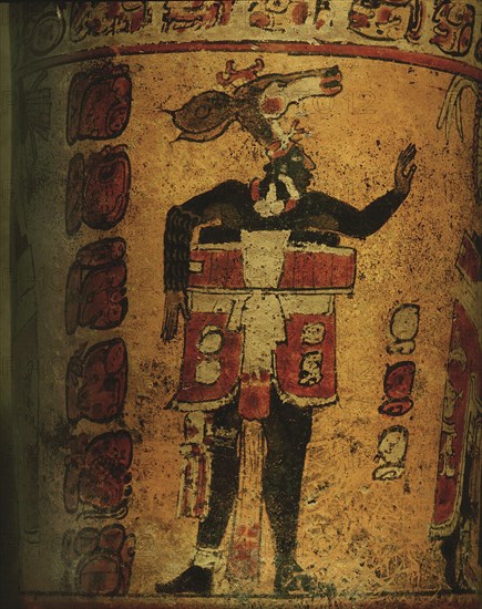 Cylindrical vessel decorated with date glyphs and a Mayan ball player wearing black body paint and heavy padding for the competition