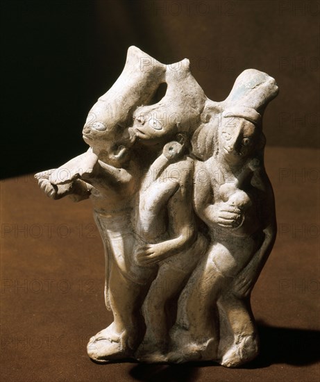 Three dancing figures