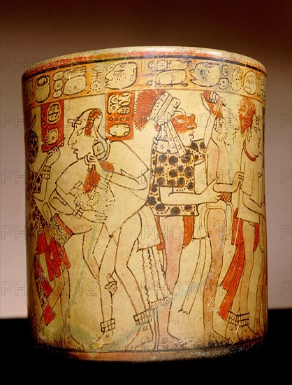 Polychrome vase decorated with glyphs and images of figures involved in battle