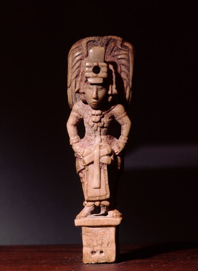 Bone carving of a Mayan dignitary wearing rich garments