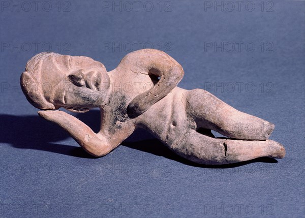 Figure of a woman lying down