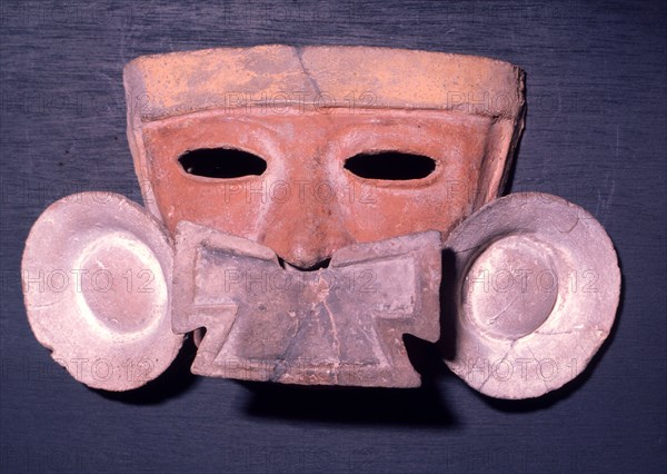 Mask showing the facial adornment worn by the nobility a nose pendant and ear spools