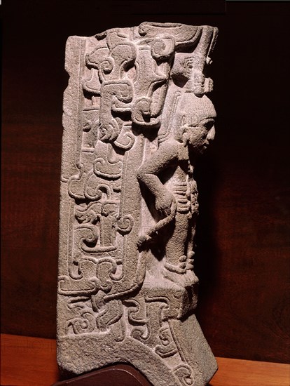 Stone carving (palmate) representing a prisoner with hands bound