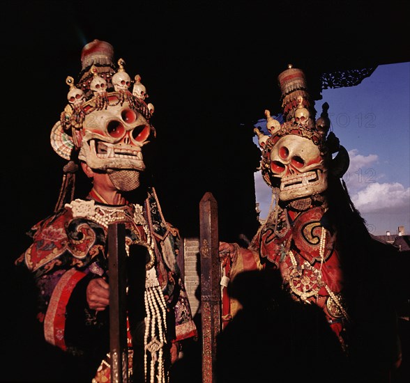 Priests dressed as black hat dancers for the sacred Cham dance