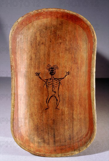 The base of a bentwood serving dish decorated with the figure of a man