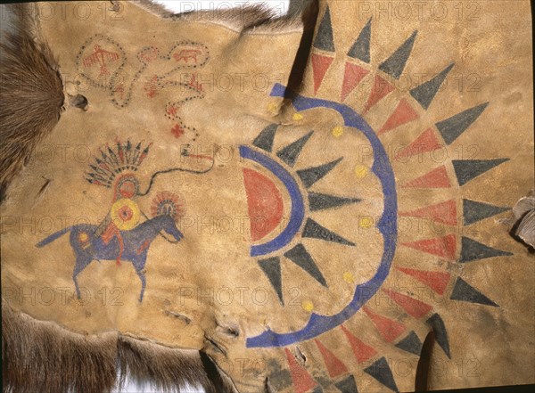 Hide painting depicting the sun burst design and a pictograph of an individuals exploits
