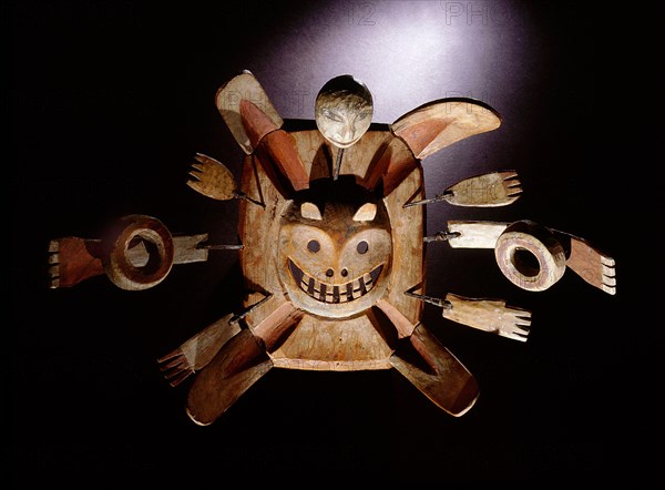 A mask probably representing a shamans spirit flight with the face in the centre representing the shamans soul