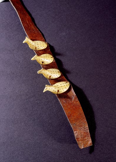 Leather bracelet with four ivory figurines representing stylized animals