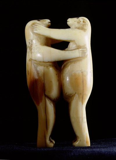 Small carving of two polar bears wrestling