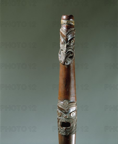 Putorino, or flute trumpet carved with three aggressive faces