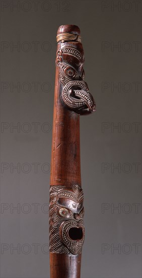 Putorino, or flute trumpet carved with three aggressive faces