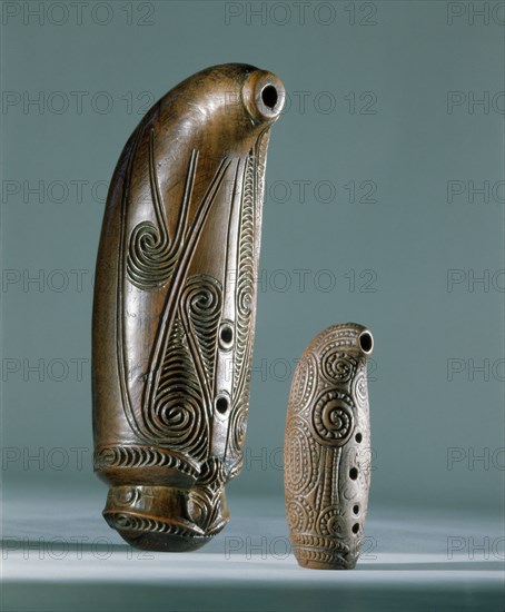 Nguru, open tube flutes, with three finger holes are blown across the wide end