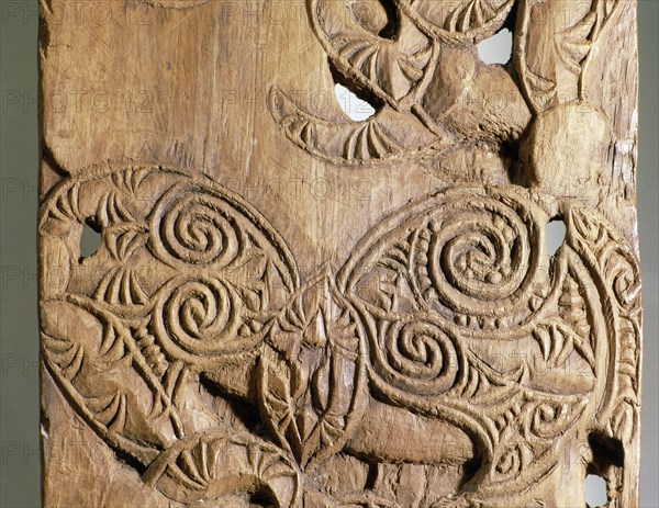 Carved in unusually low relief, this end post, epa, from a Taranaki storehouse depicts the interaction of ancestral figures and manaia, profile figures representing the supernatural world