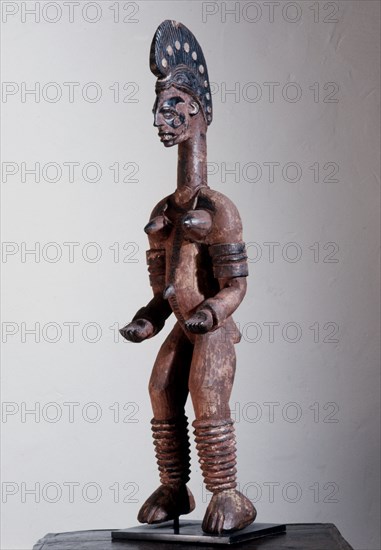 Female shrine figure, part of a family of such figures kept in a village shrine, illustrating the continuity of social roles in the world of the living and that of the spirits