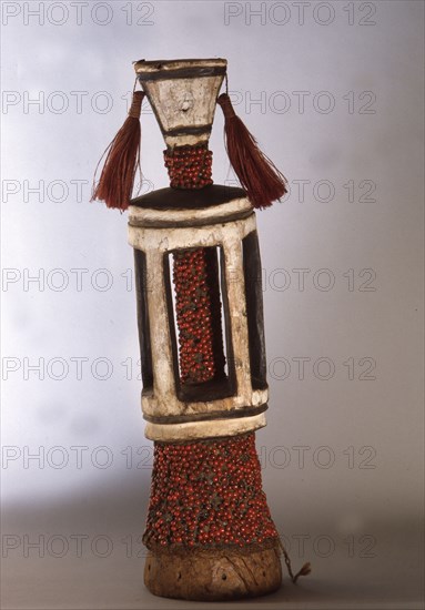 Stylised human figure covered with red abrus seeds