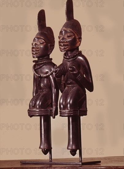 Dance staffs depicting male and female devotees of Eshu, identifiable by the projection from their heads